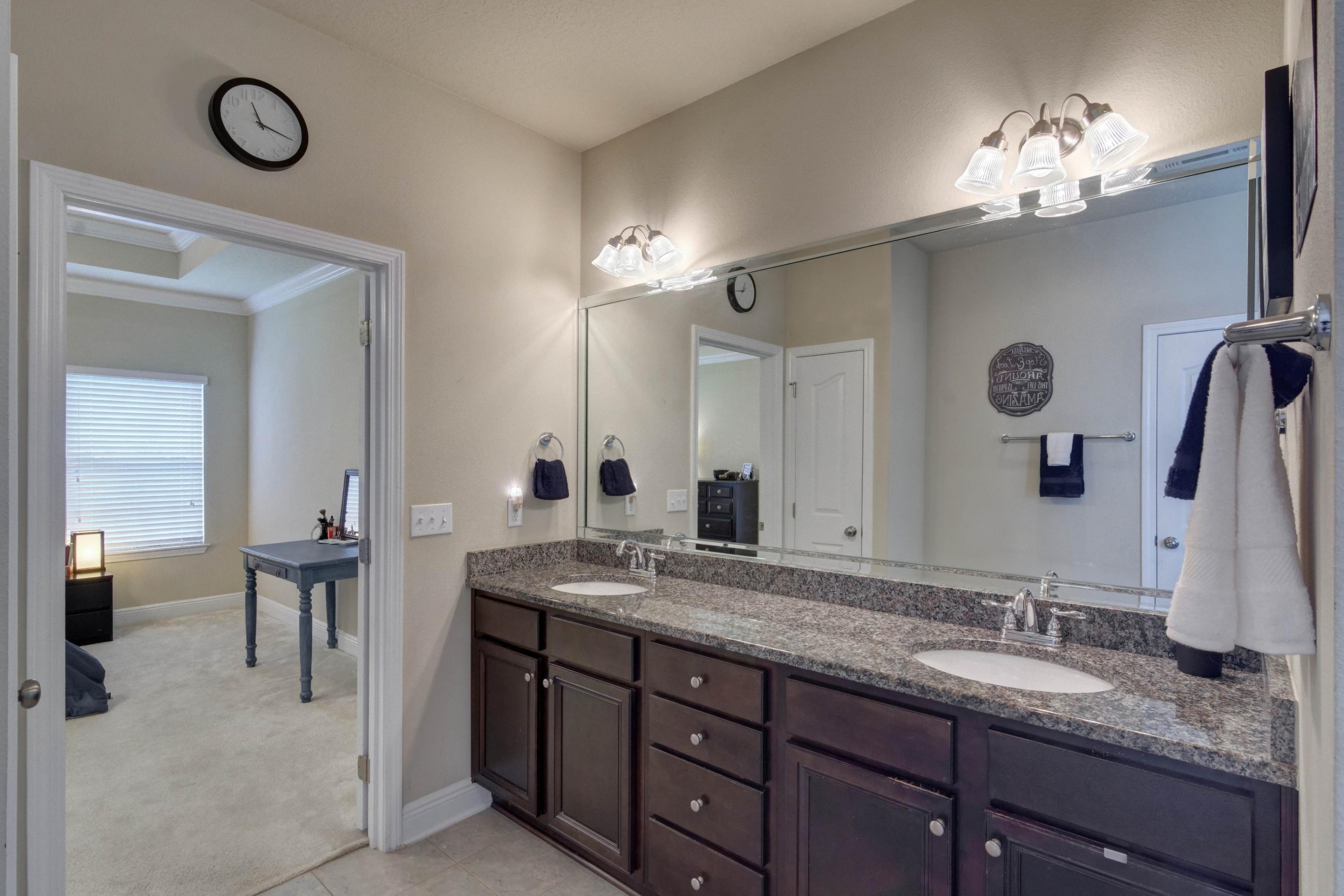 646 Red Fern Road Crestview, FL 32536 - Photo 39 of 64 a bathroom with a granite countertop sink a large mirror and a shower