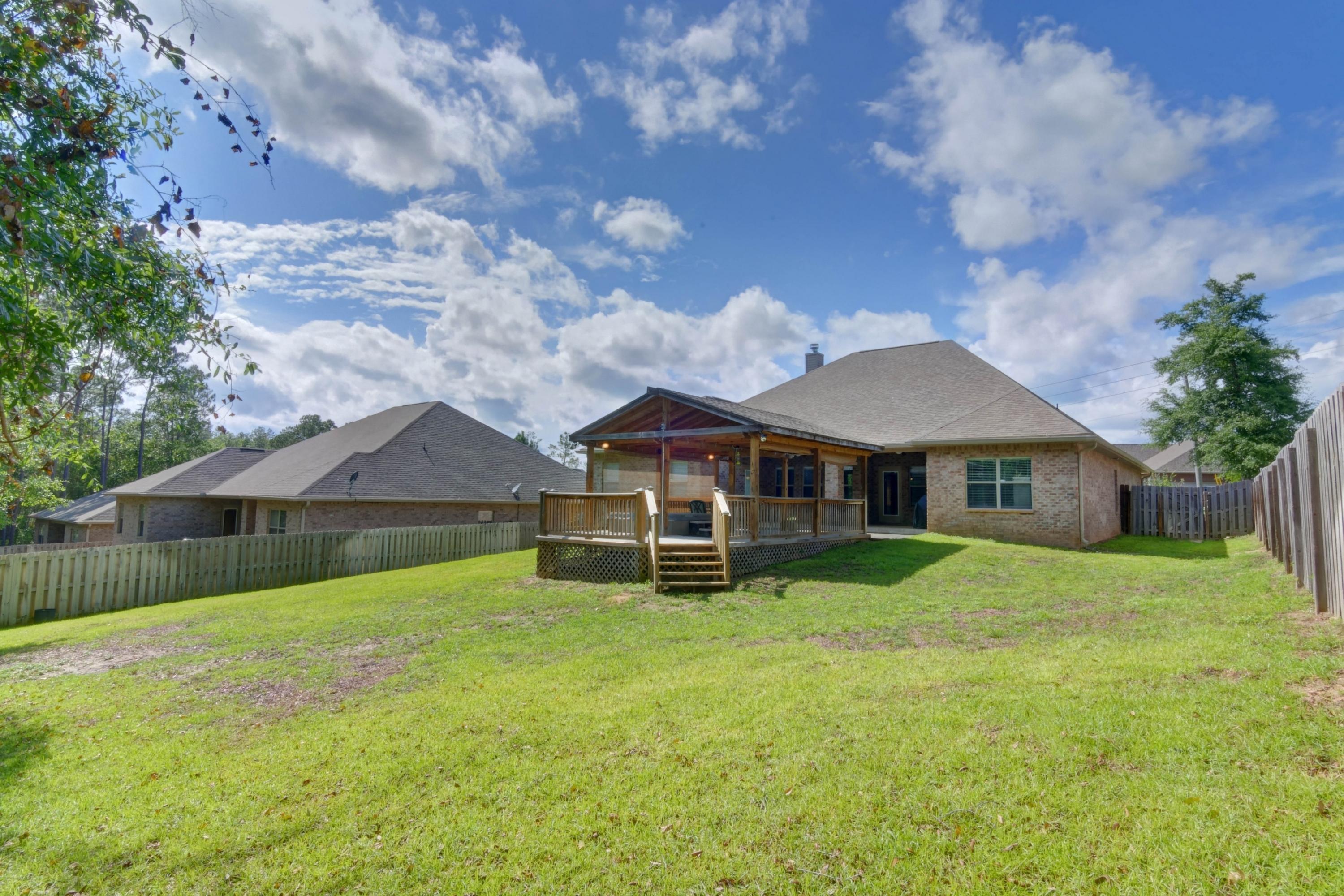 646 Red Fern Road Crestview, FL 32536 - Photo 58 of 64 a backyard of a house with table and chairs