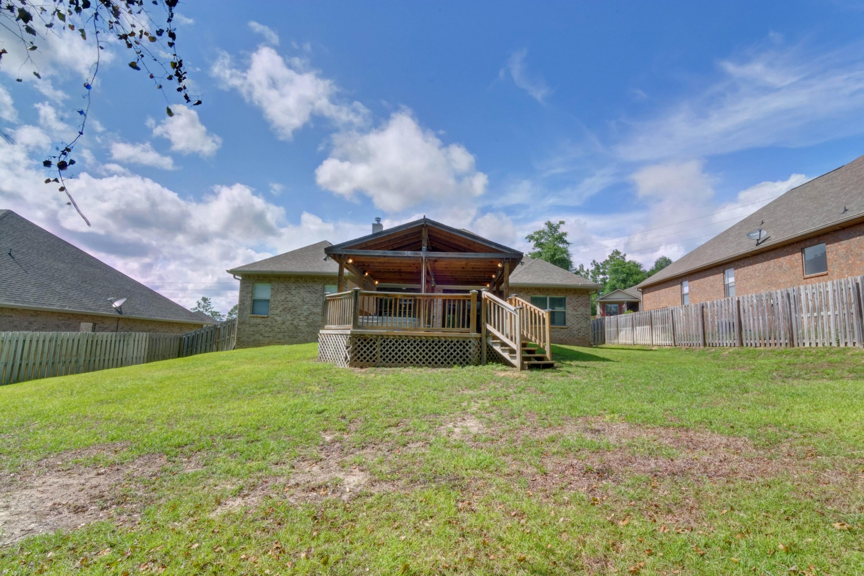 646 Red Fern Road Crestview, FL 32536 - Photo 59 of 64 a yellow house sitting in middle of the park