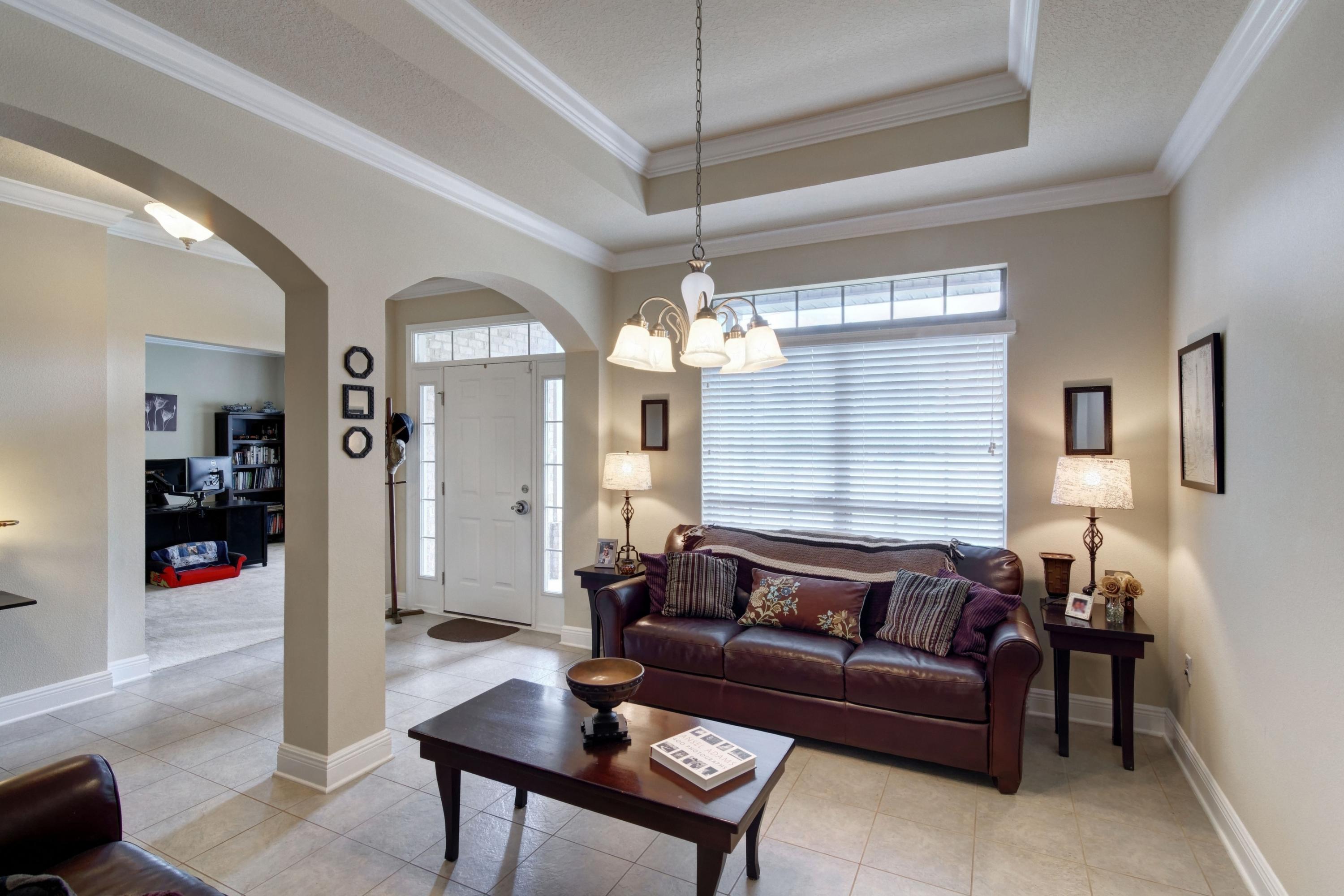 646 Red Fern Road Crestview, FL 32536 - Photo 7 of 64 a living room with furniture a chandelier and a chandelier