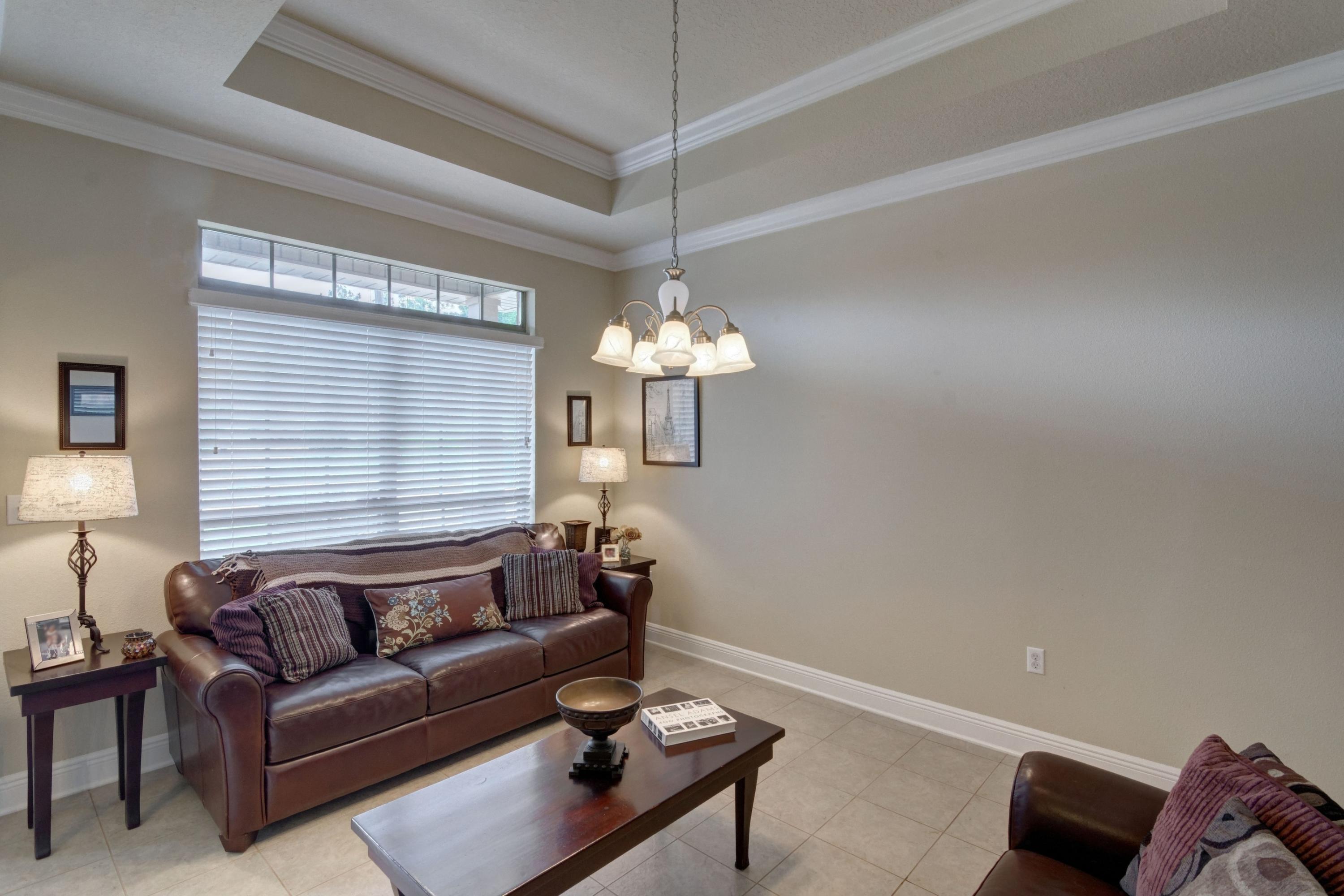 646 Red Fern Road Crestview, FL 32536 - Photo 8 of 64 a living room with furniture a window and a chandelier
