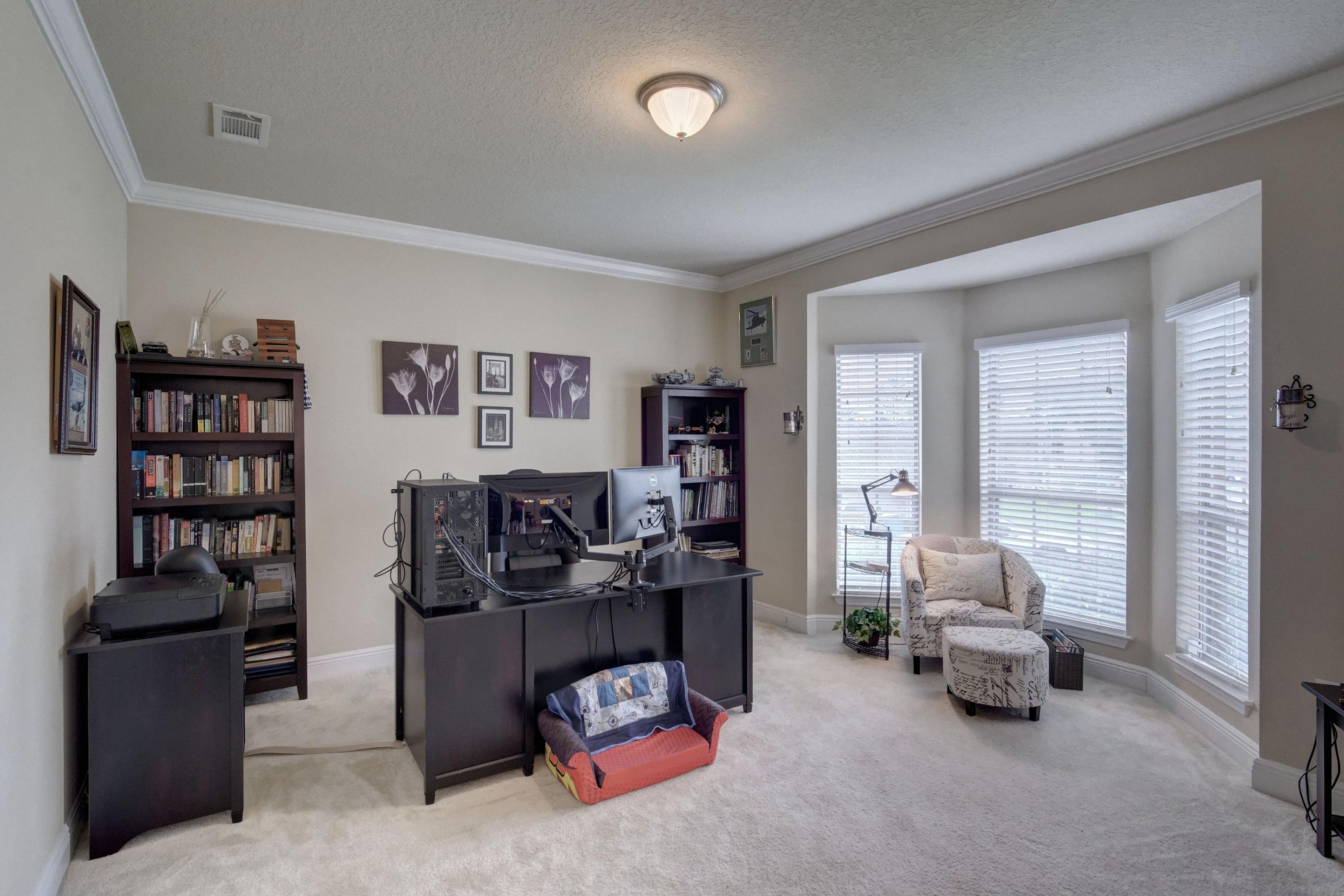 646 Red Fern Road Crestview, FL 32536 - Photo 10 of 64 a bedroom with furniture and a book shelf