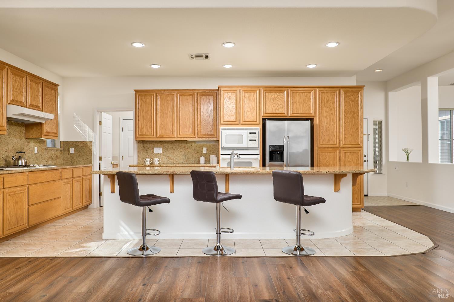 604 American Falls Drive Rio Vista, CA 94571 - Photo 14 of 39 a kitchen with stainless steel appliances granite countertop a stove top oven a sink a counter space and cabinets