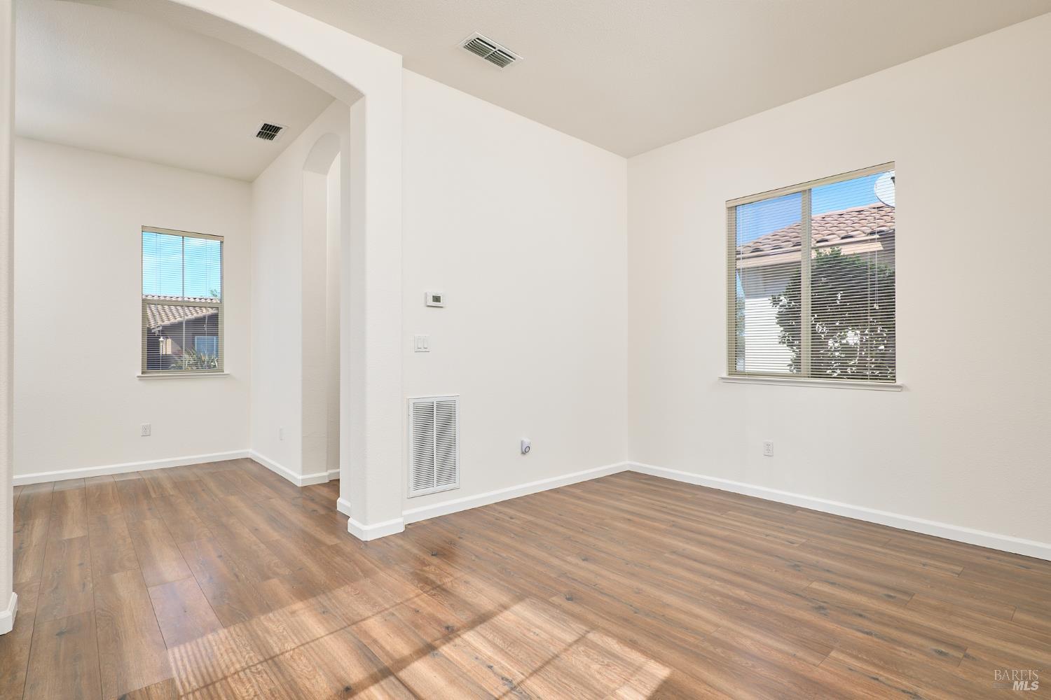 604 American Falls Drive Rio Vista, CA 94571 - Photo 25 of 39 an empty room with wooden floor and windows