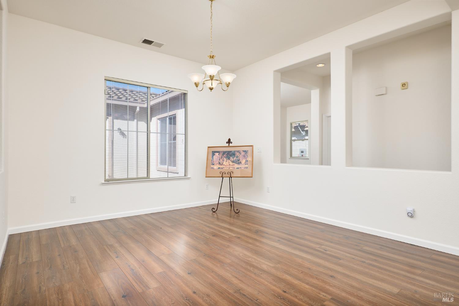 604 American Falls Drive Rio Vista, CA 94571 - Photo 7 of 39 a view of an empty room with window and wooden floor