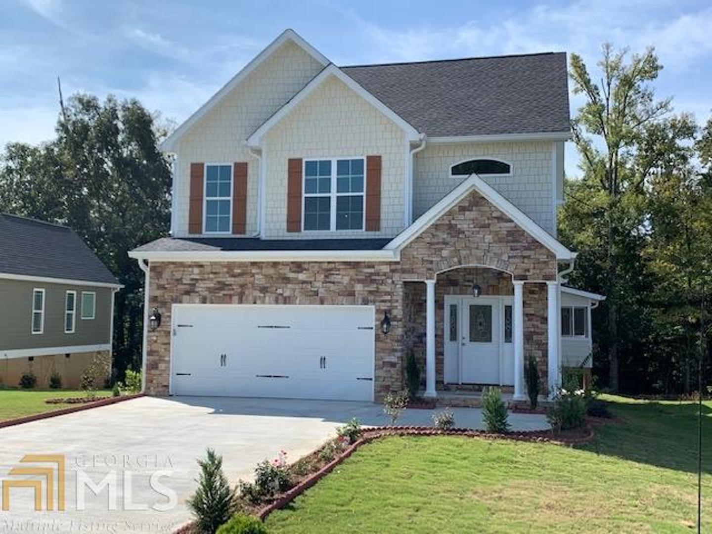 84 Round Rock Circle Northeast Rome, GA 30161 - Photo 1 of 1 a front view of a house with a yard garage and outdoor seating