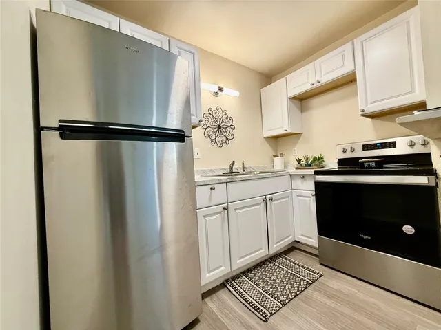 a kitchen with a sink and a refrigerator