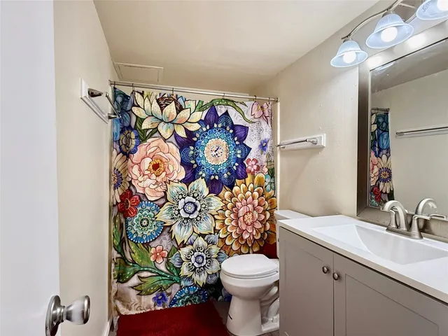 a white toilet sitting next to a bathroom sink