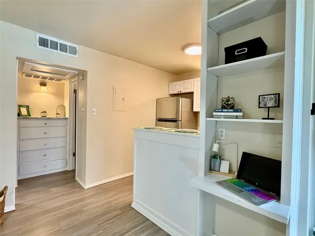 a kitchen with a refrigerator and a stove