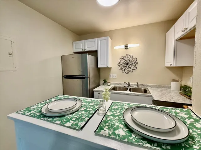 a kitchen with a table and chairs in it
