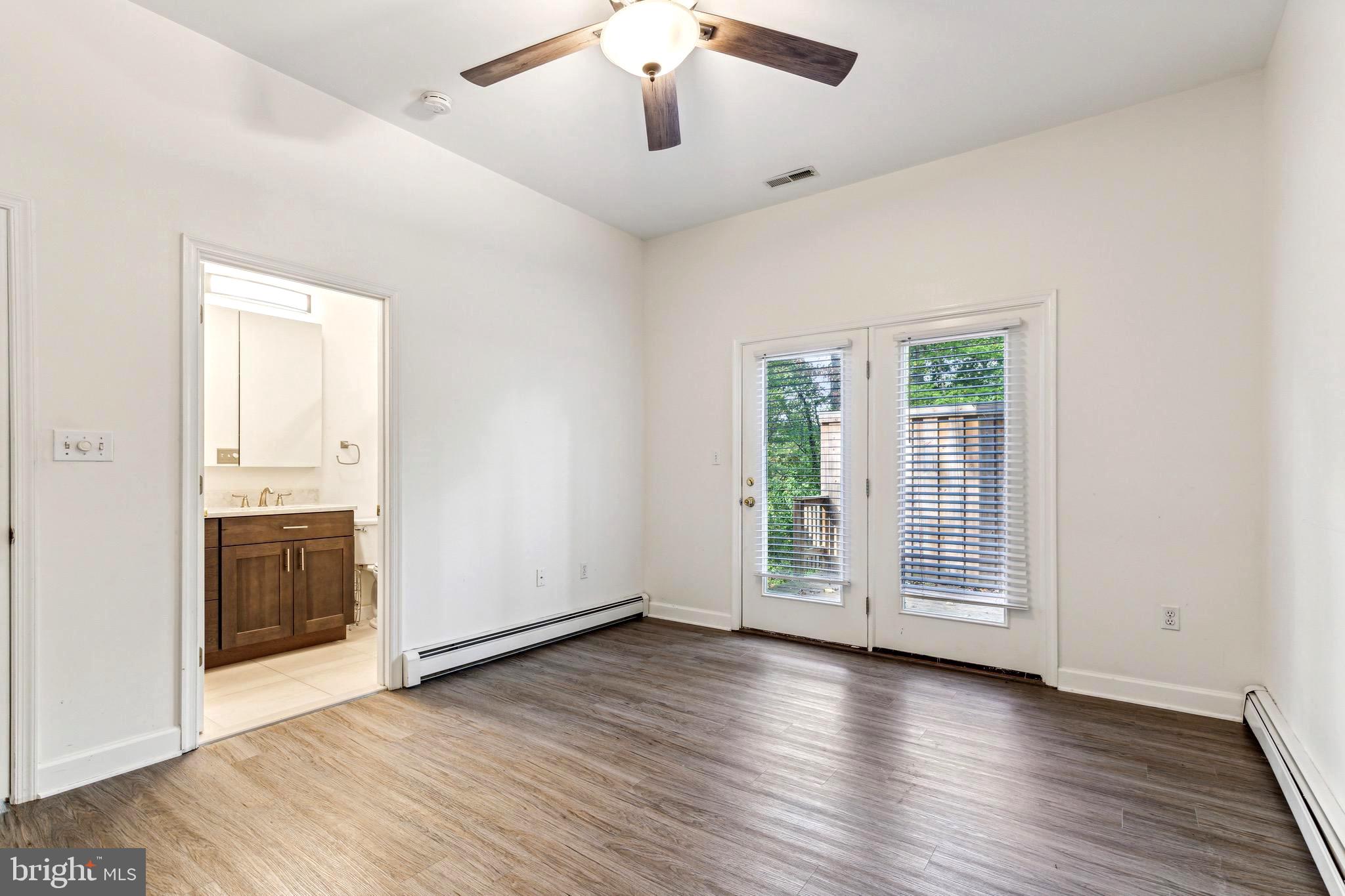 1500 St Margarets Road Annapolis, MD 21409 - Photo 11 of 18 an empty room with wooden floor cabinet and windows