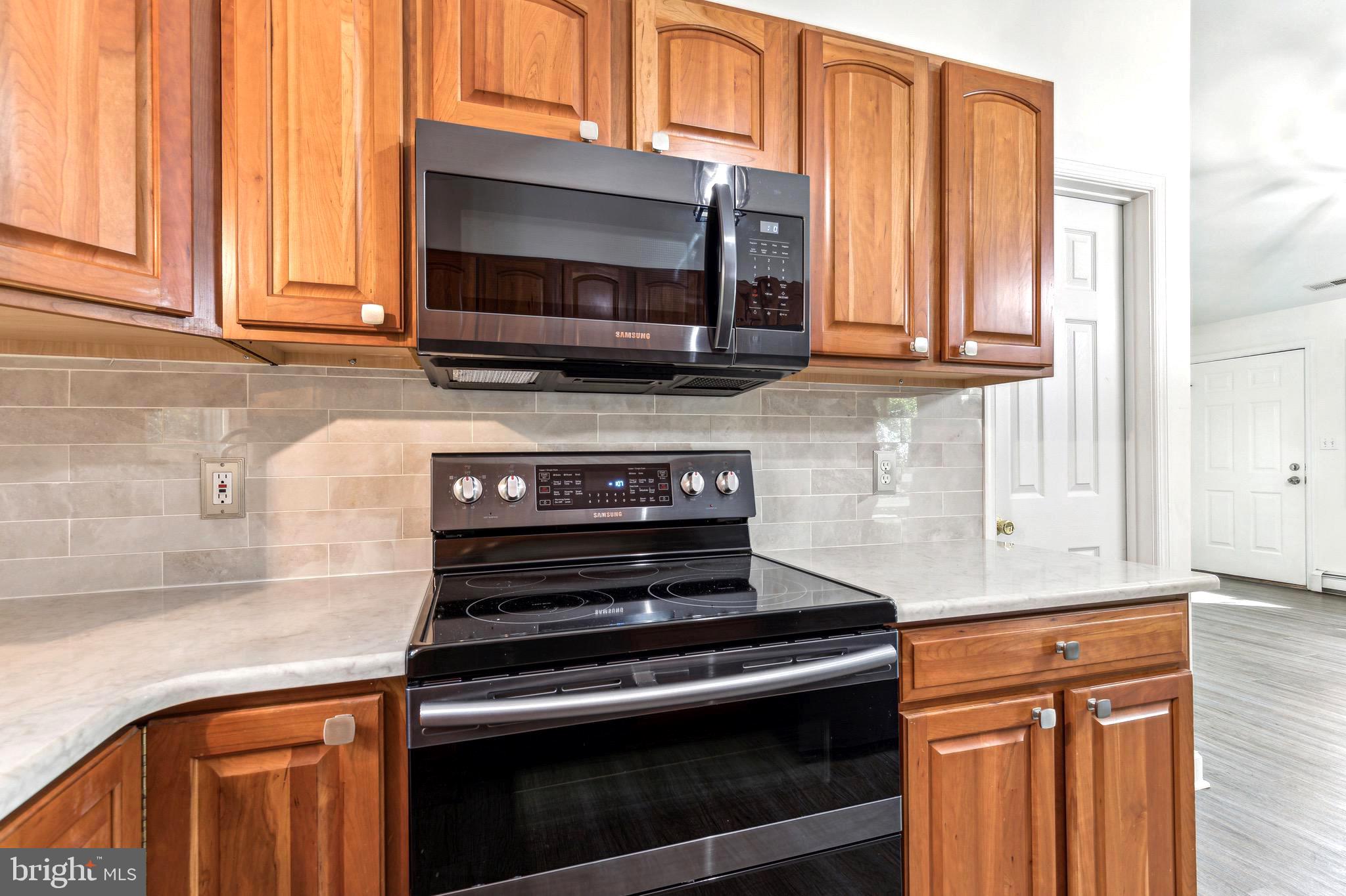 1500 St Margarets Road Annapolis, MD 21409 - Photo 2 of 18 a kitchen with stainless steel appliances granite countertop a stove microwave and cabinets