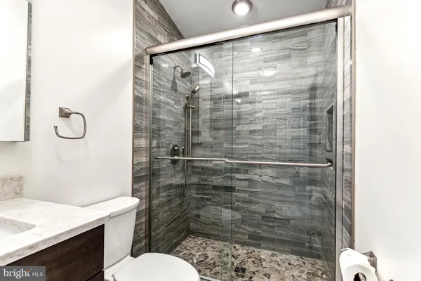 a bathroom with a shower toilet and sink