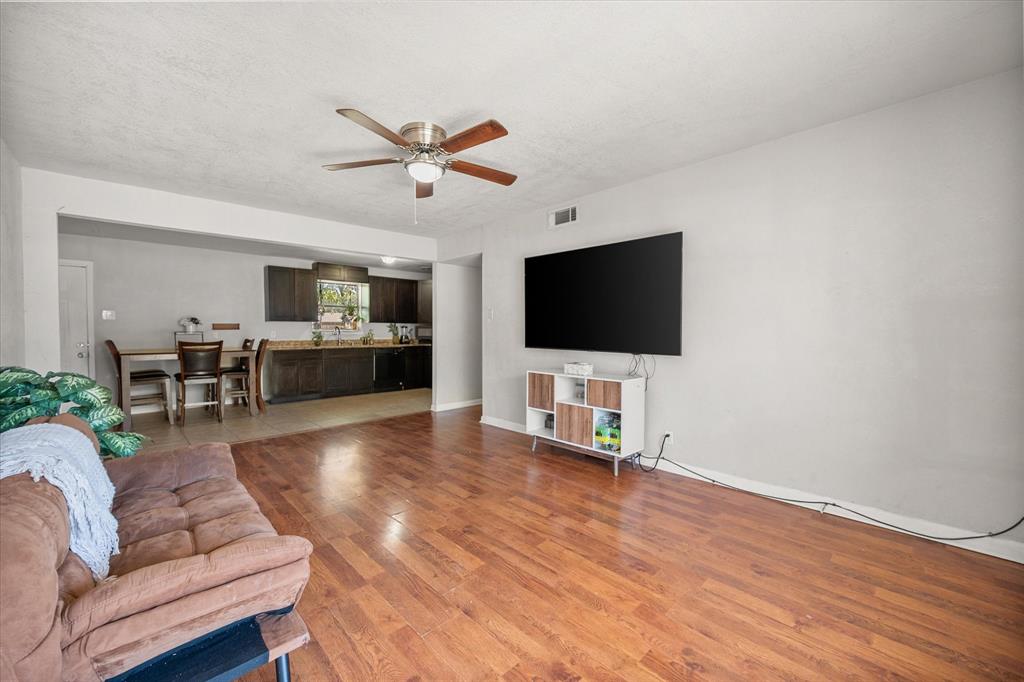 1437 Roma Lane Fort Worth, TX 76134 - Photo 4 of 20 a living room with furniture and a flat screen tv