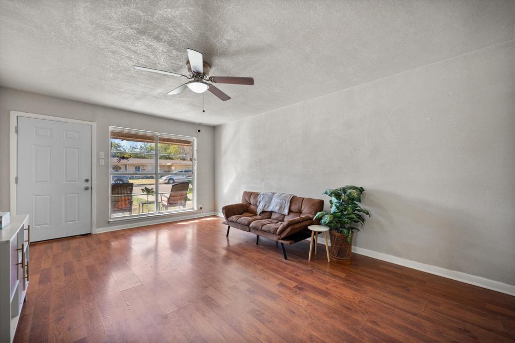 1437 Roma Lane Fort Worth, TX 76134 - Photo 6 of 20 a dining room with furniture a chandelier and wooden floor