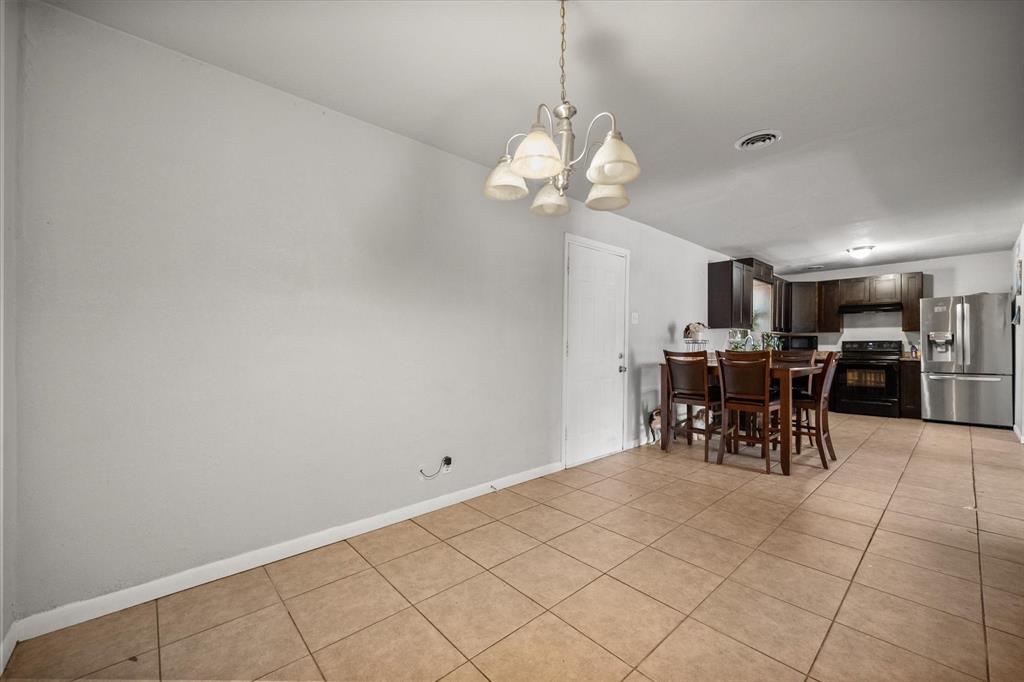 1437 Roma Lane Fort Worth, TX 76134 - Photo 7 of 20 a view of a dining room and kitchen with a chandelier
