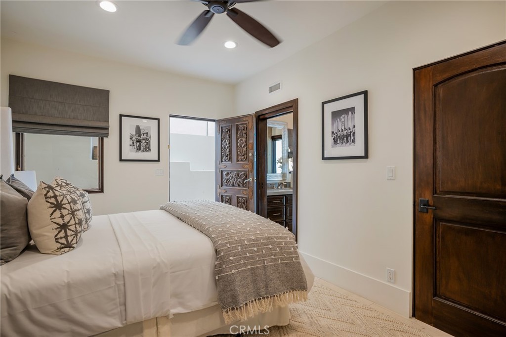 709 Esplanade Redondo Beach, CA 90277 - Photo 22 of 75 a bedroom with a large bed and a chandelier