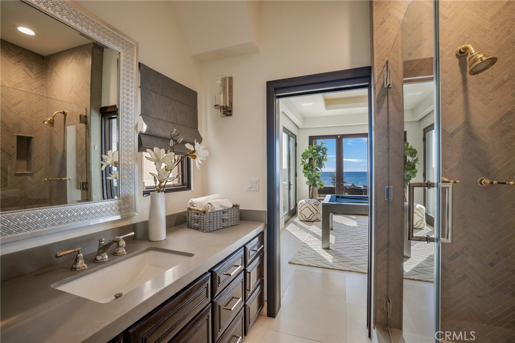 709 Esplanade Redondo Beach, CA 90277 - Photo 23 of 75 a en suite bathroom with a granite countertop sink and a mirror