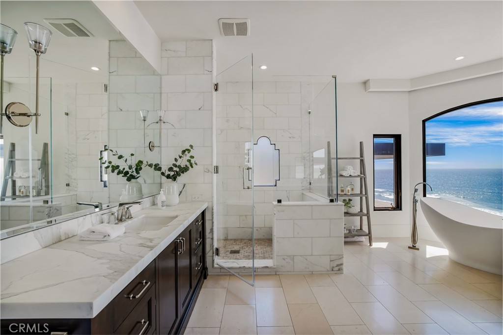 709 Esplanade Redondo Beach, CA 90277 - Photo 39 of 75 a spacious bathroom with a double vanity sink a large mirror and a bathtub