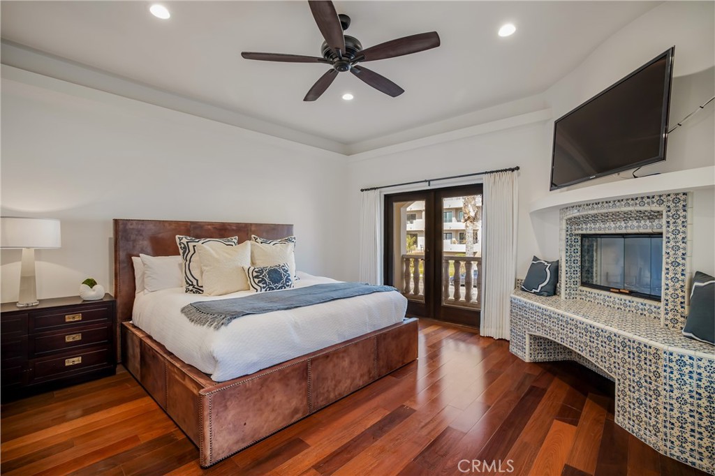 709 Esplanade Redondo Beach, CA 90277 - Photo 40 of 75 a bedroom with a bed and a flat screen tv