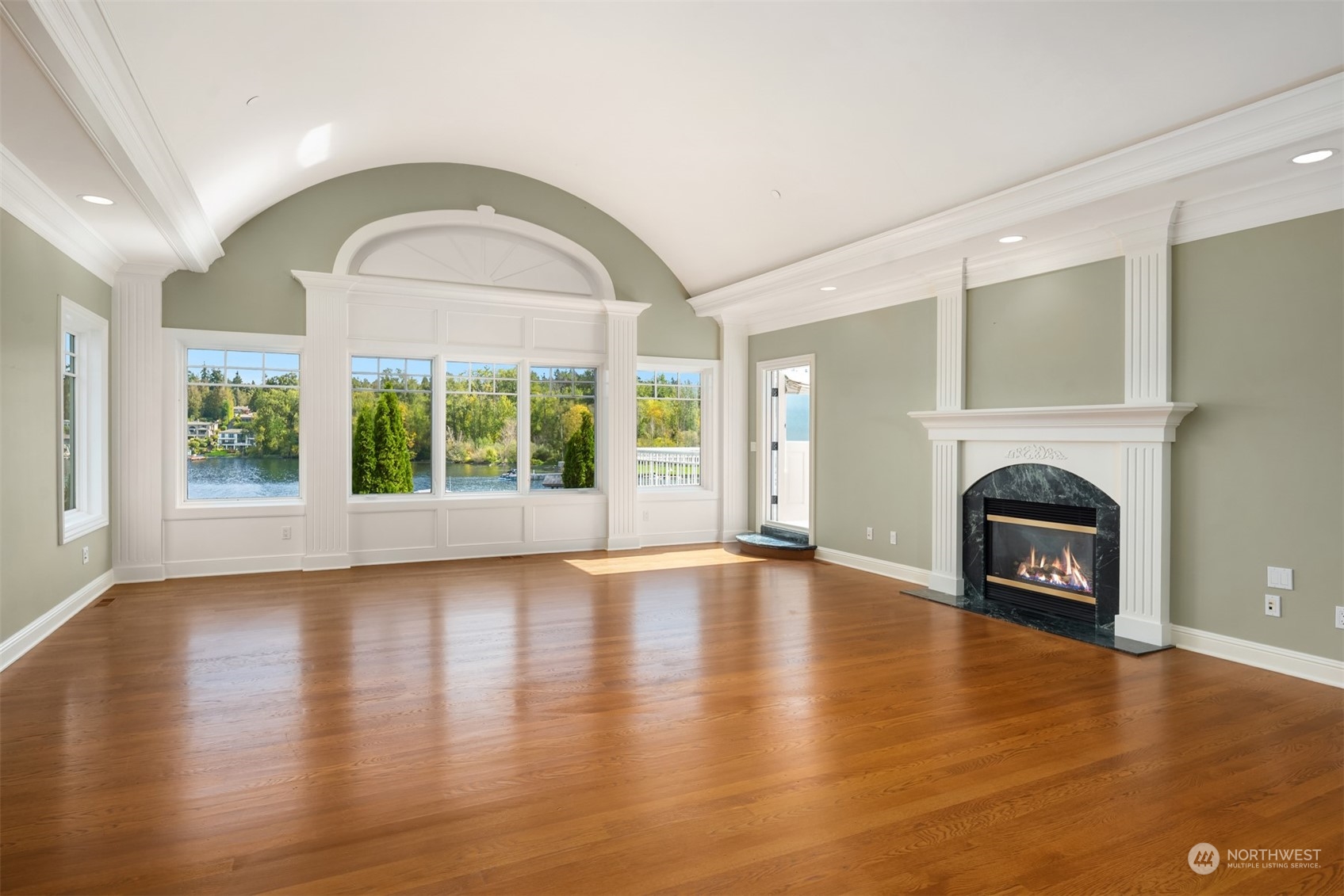 3252 Hunts Point Road Hunts Point, WA 98004 - Photo 14 of 21 a view of an empty room with wooden floor and a fireplace