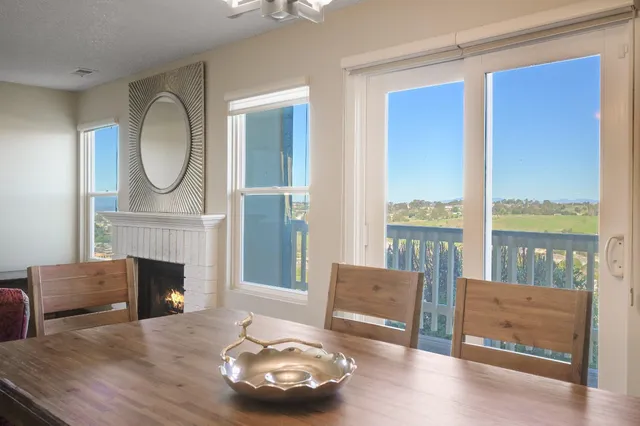 a view of a dining room with furniture and a window