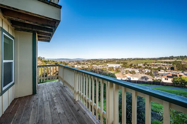 a large white kitchen with a sink and dishwasher a stove with wooden floor