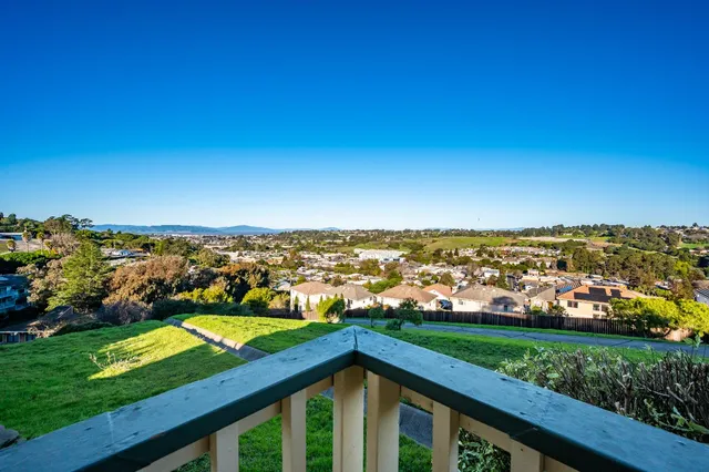 a bedroom with two beds and a large window