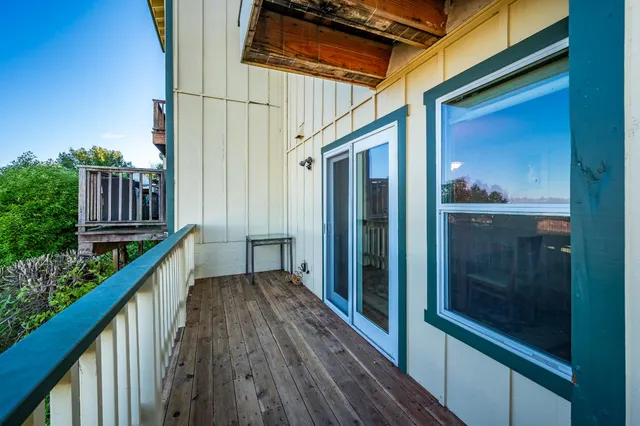a bathroom with a granite countertop sink a toilet and a mirror
