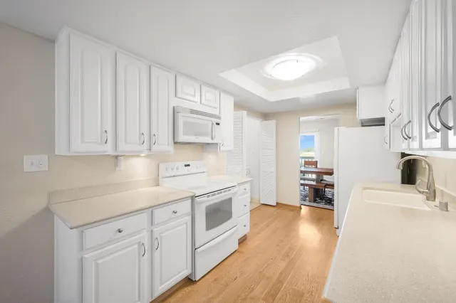 a bathroom with a double vanity sink toilet and a mirror