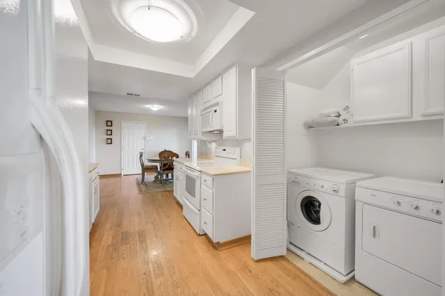 an aerial view of a city with lots of residential buildings and ocean view in back