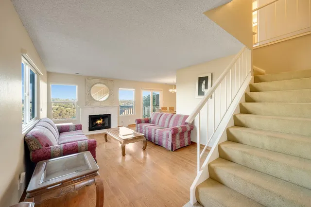 a living room with furniture a fireplace and a table