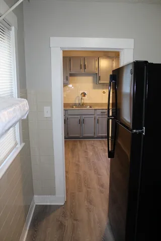 a kitchen with a refrigerator and a sink