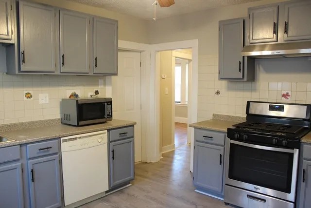 a kitchen with stainless steel appliances granite countertop a stove a microwave and cabinets