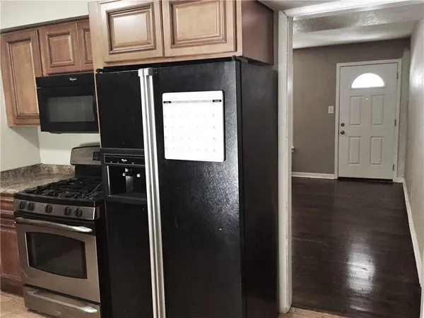 a kitchen with stainless steel appliances granite countertop a stove and a microwave