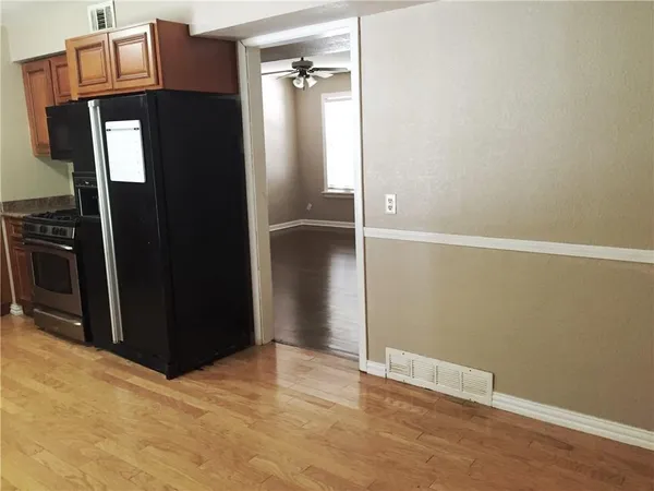 a view of a kitchen with wooden cabinets