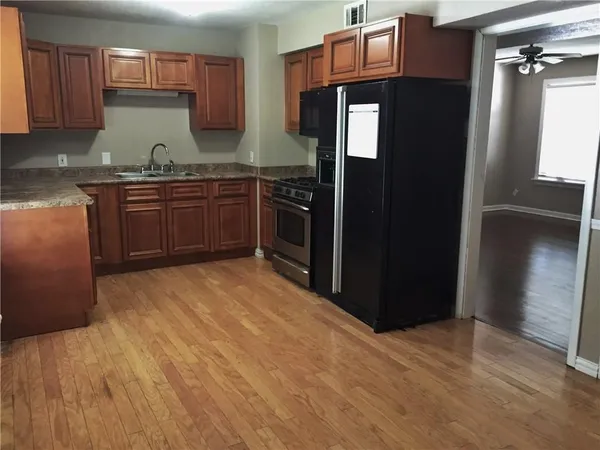 a kitchen with stainless steel appliances granite countertop a refrigerator and a stove
