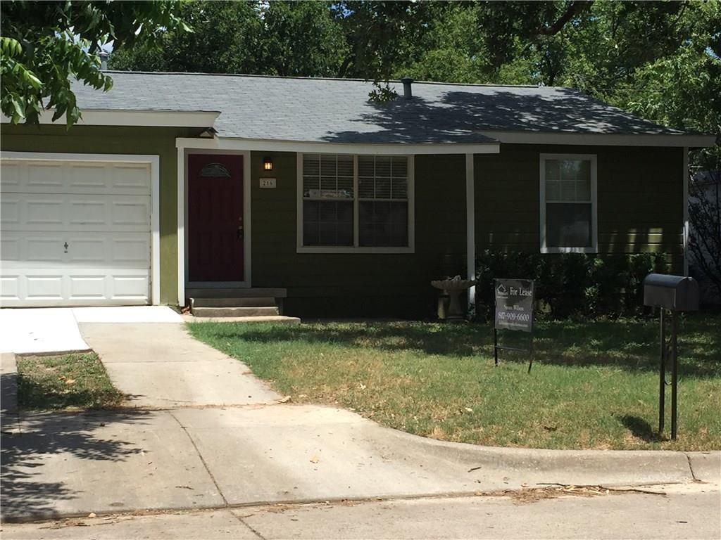 216 Elm Street Hurst, TX 76053 - Photo 17 of 17 Single-story residence featuring a dark green exterior, white trim, and a red entry door with decorative glass