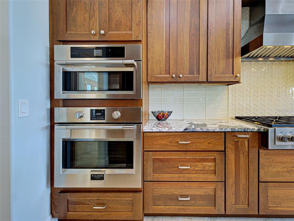 431 Tremingham Way Venice, FL 34293 - Photo 15 of 66 a kitchen with granite countertop white cabinets and stainless steel appliances