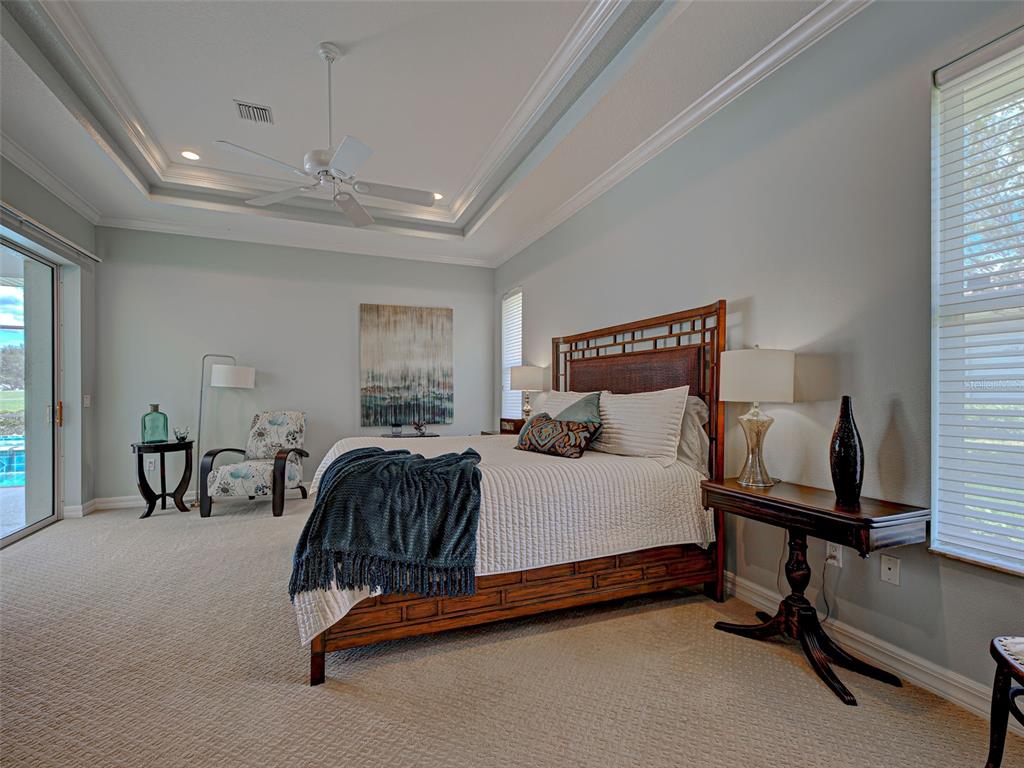 431 Tremingham Way Venice, FL 34293 - Photo 33 of 66 a bedroom with a bed and a chandelier