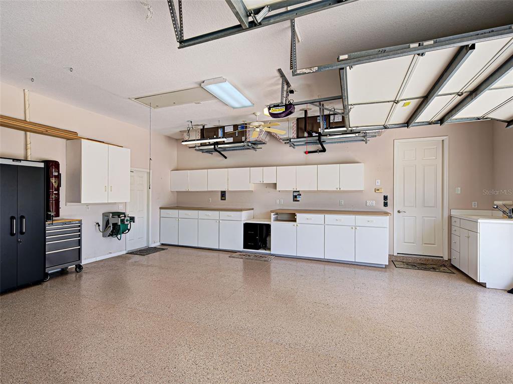 431 Tremingham Way Venice, FL 34293 - Photo 61 of 66 a large white kitchen with a stove and a refrigerator