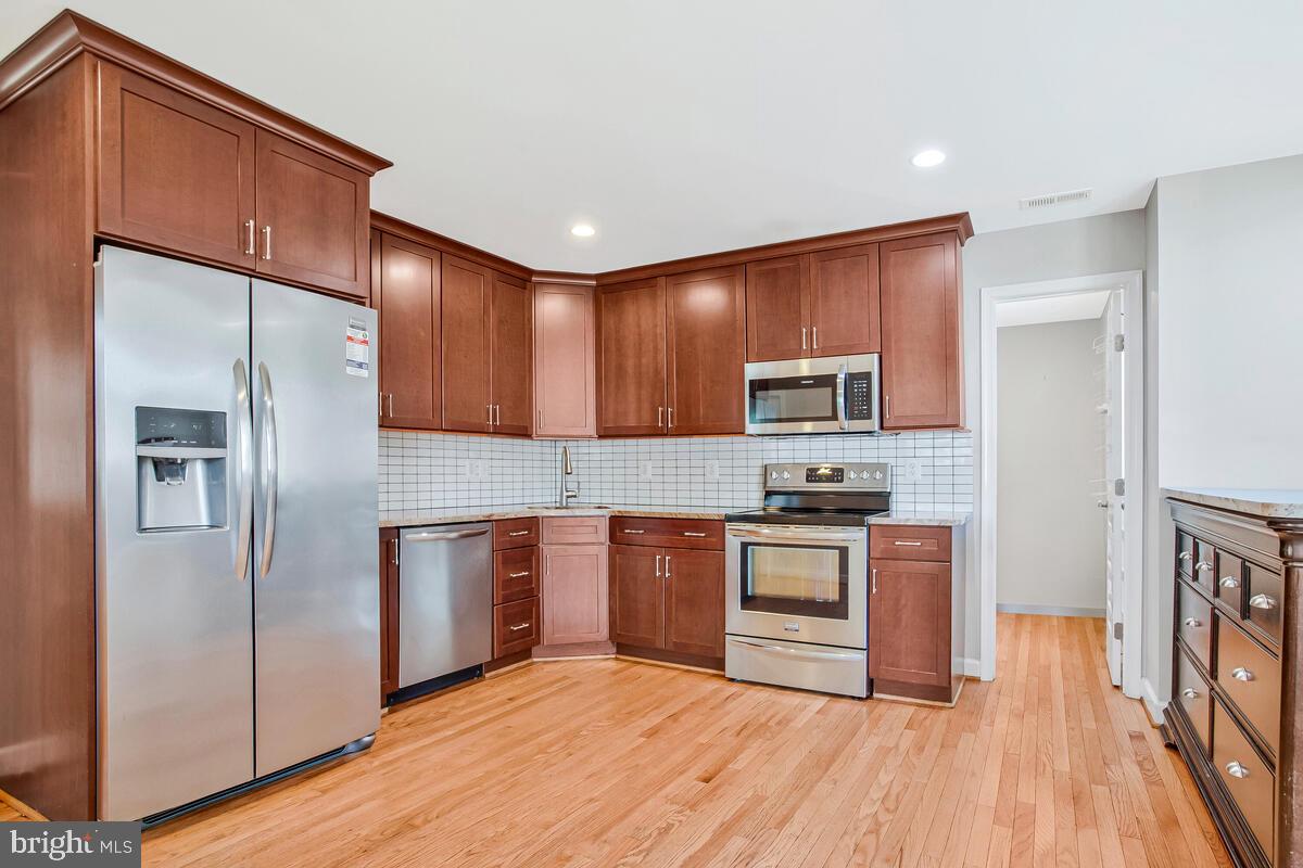 1533 Wakefield Road Edgewater, MD 21037 - Photo 11 of 41 a kitchen with stainless steel appliances granite countertop a refrigerator stove and sink