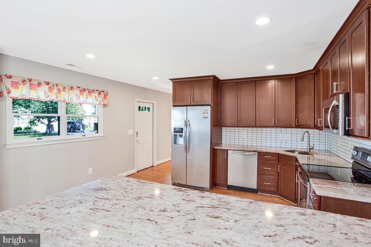 1533 Wakefield Road Edgewater, MD 21037 - Photo 12 of 41 a kitchen with stainless steel appliances granite countertop a refrigerator and a sink