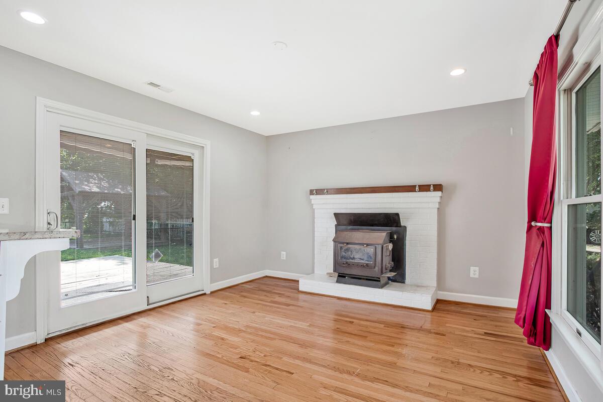 1533 Wakefield Road Edgewater, MD 21037 - Photo 14 of 41 a view of an empty room with wooden floor and a fireplace