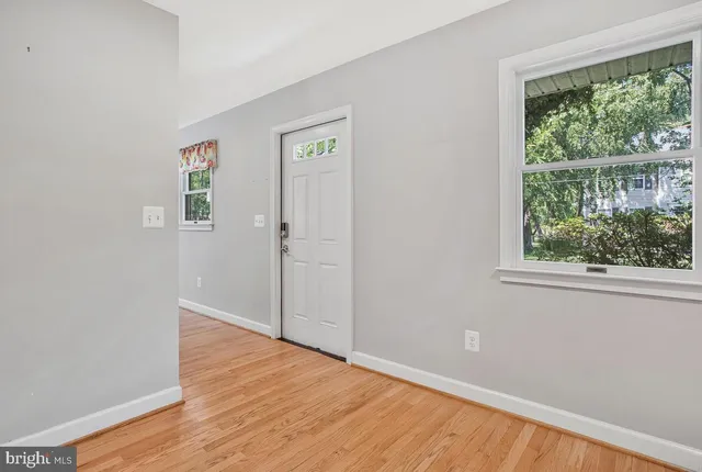 wooden floor in an empty room with a window