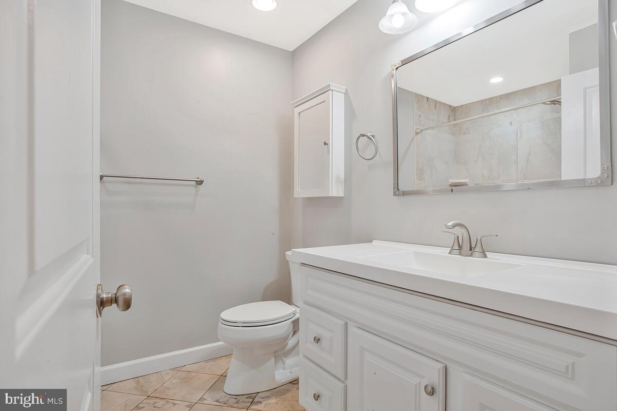 1533 Wakefield Road Edgewater, MD 21037 - Photo 19 of 41 a bathroom with a sink toilet and mirror