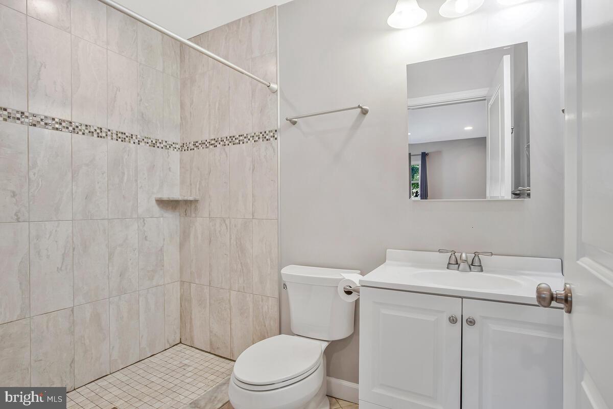 1533 Wakefield Road Edgewater, MD 21037 - Photo 30 of 41 a bathroom with a sink a toilet and shower