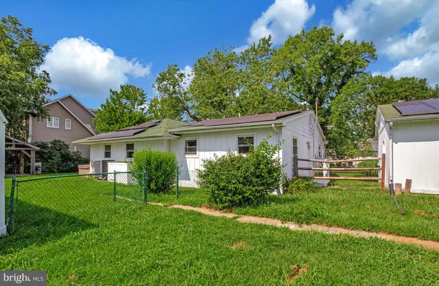 a view of a backyard with table and chairs under an umbrella