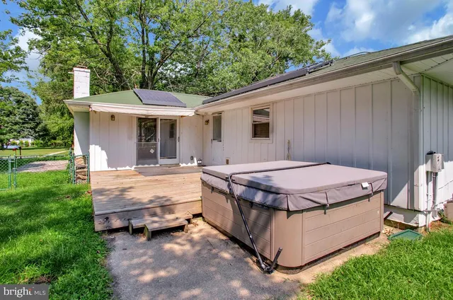 a view of a backyard with wooden floor barbeque and outdoor seating