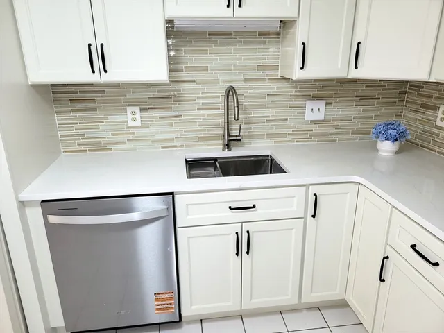 a kitchen with a sink and cabinets